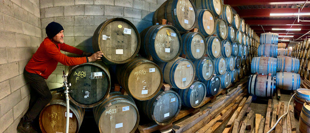 Winemaker Chris Williams tasting in the barrel room to unsure wine making is on schedule. 